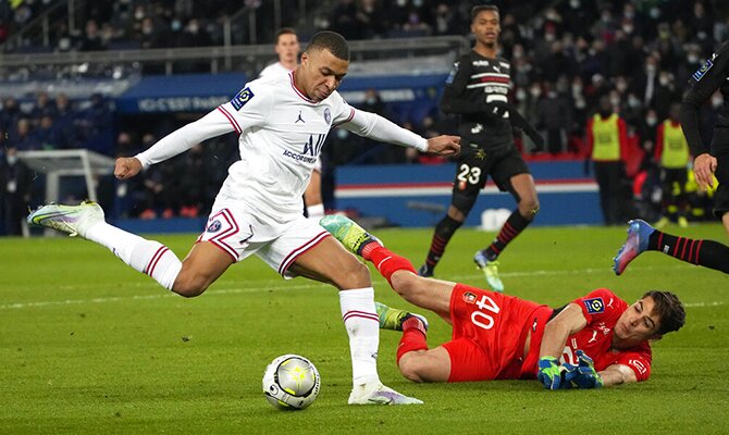 Kylian Mbappé driblando a un portero para hacer gol. Cuotas para el PSG vs Real Madrid.