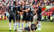 Jugadores del Arsenal forman una barrera en partido ante el Brentford