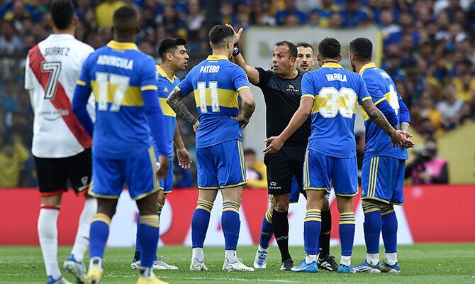 Jugadores de Boca Juniors reclaman al arbitro en el superclásico ante River en 2022